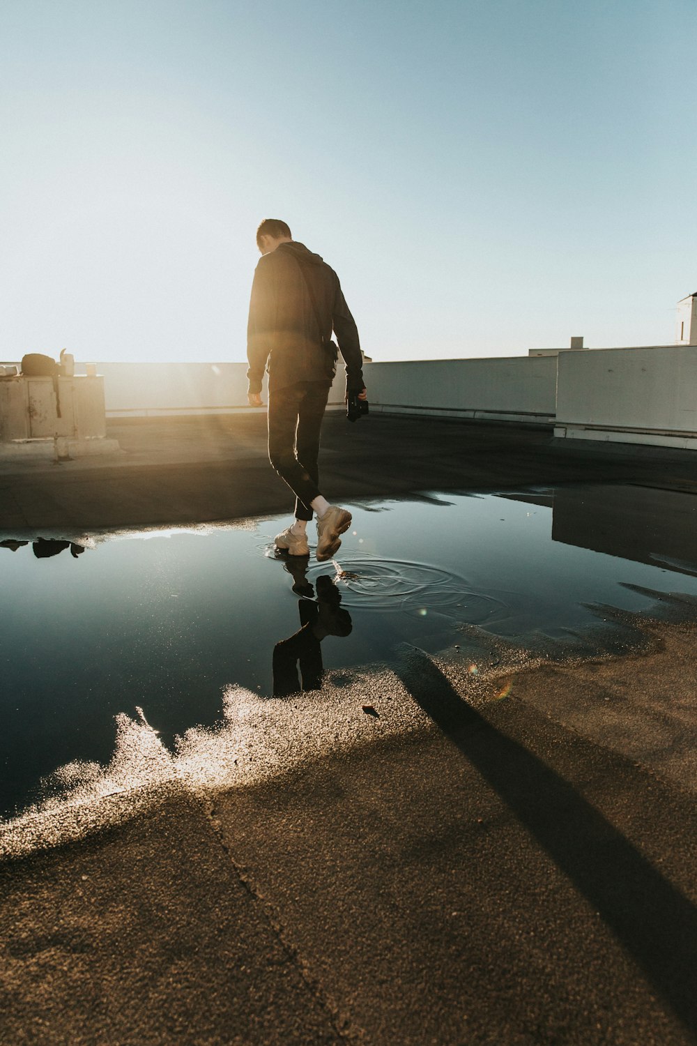 man walking on water puddle