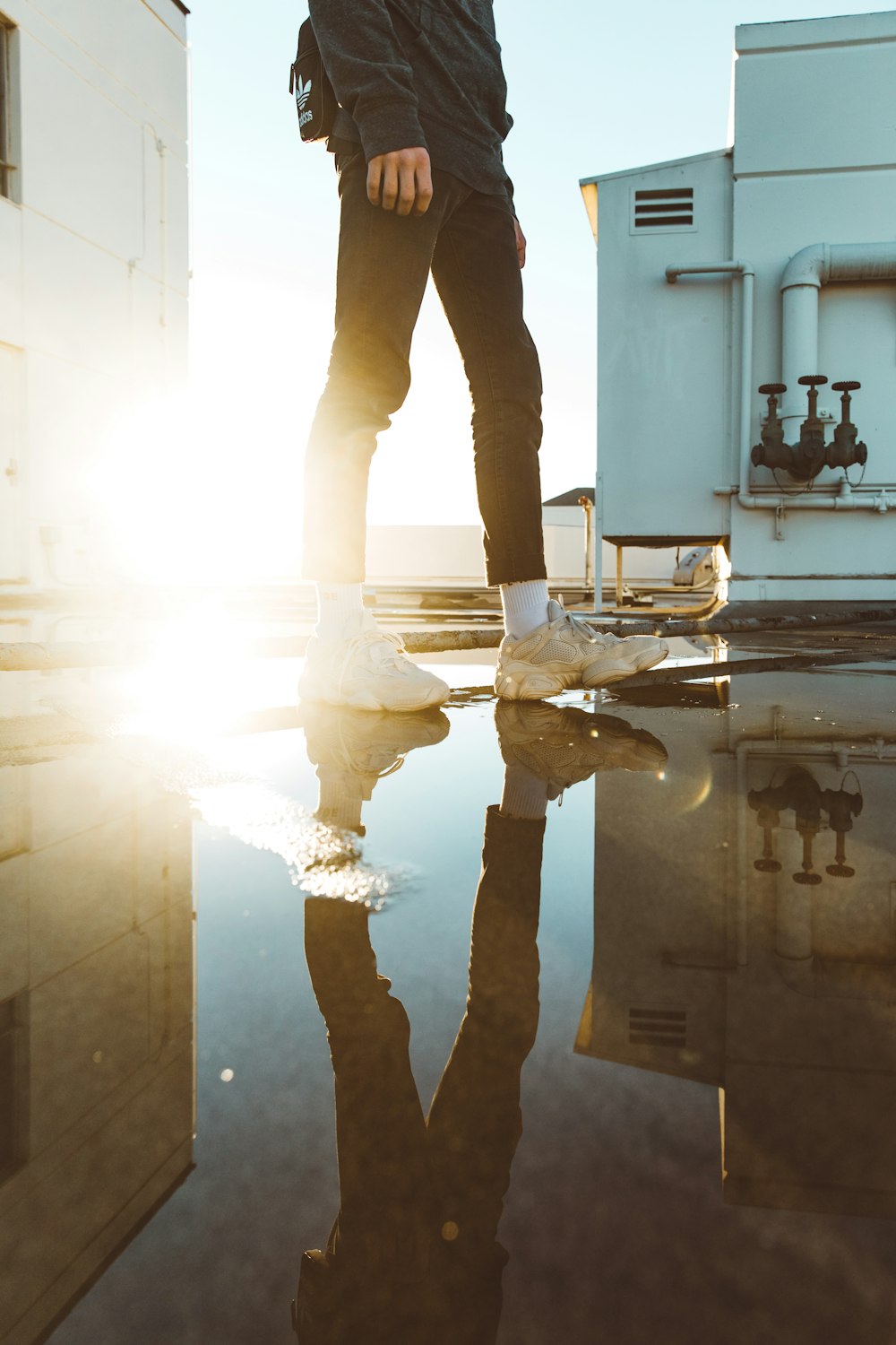man standing on a puddle