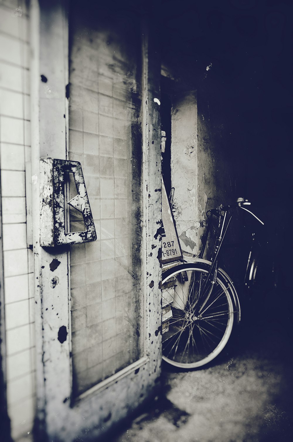 bicycle parked next to wall