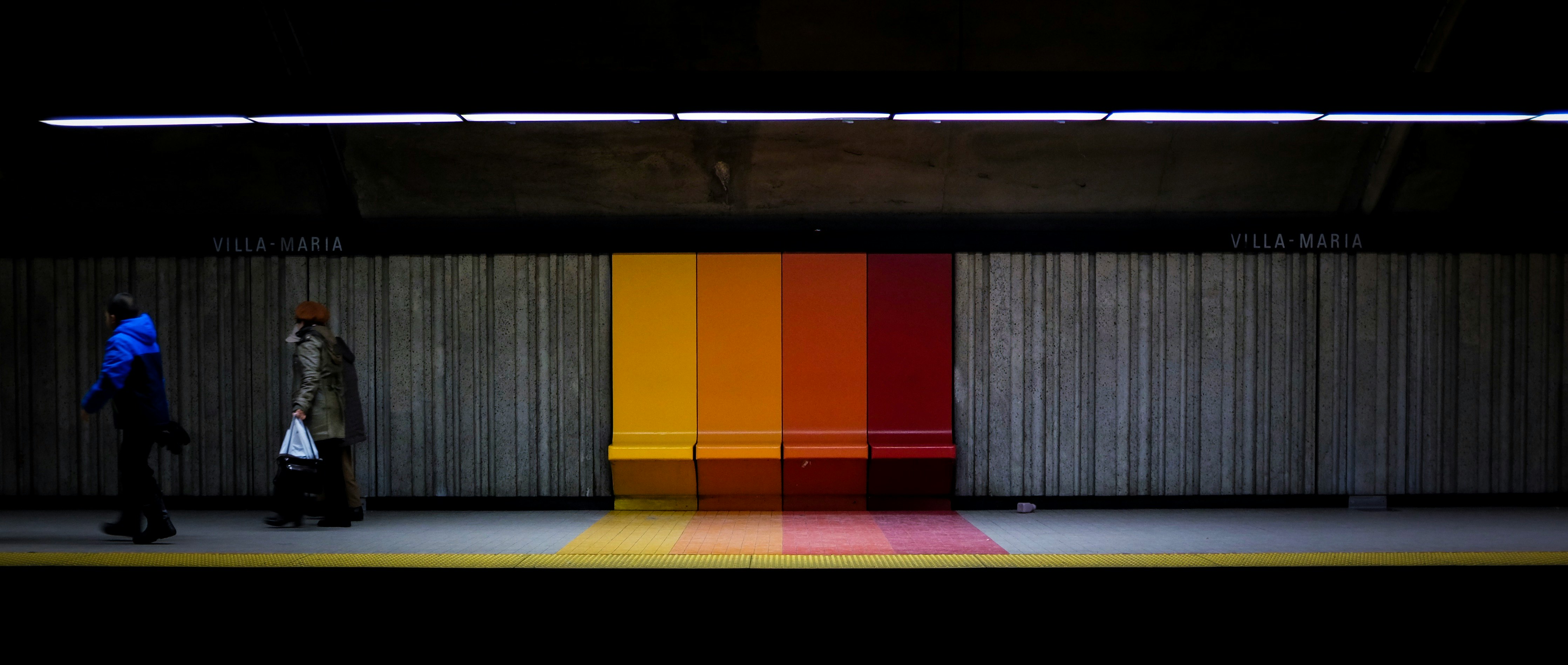 two person at train station during daytime