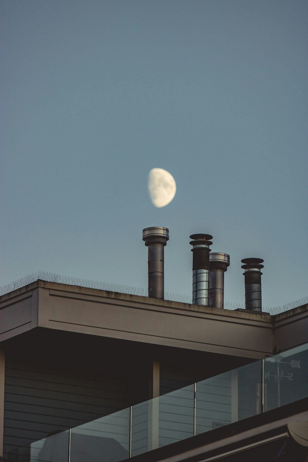  view of the moon on the sky and chimneys chimney