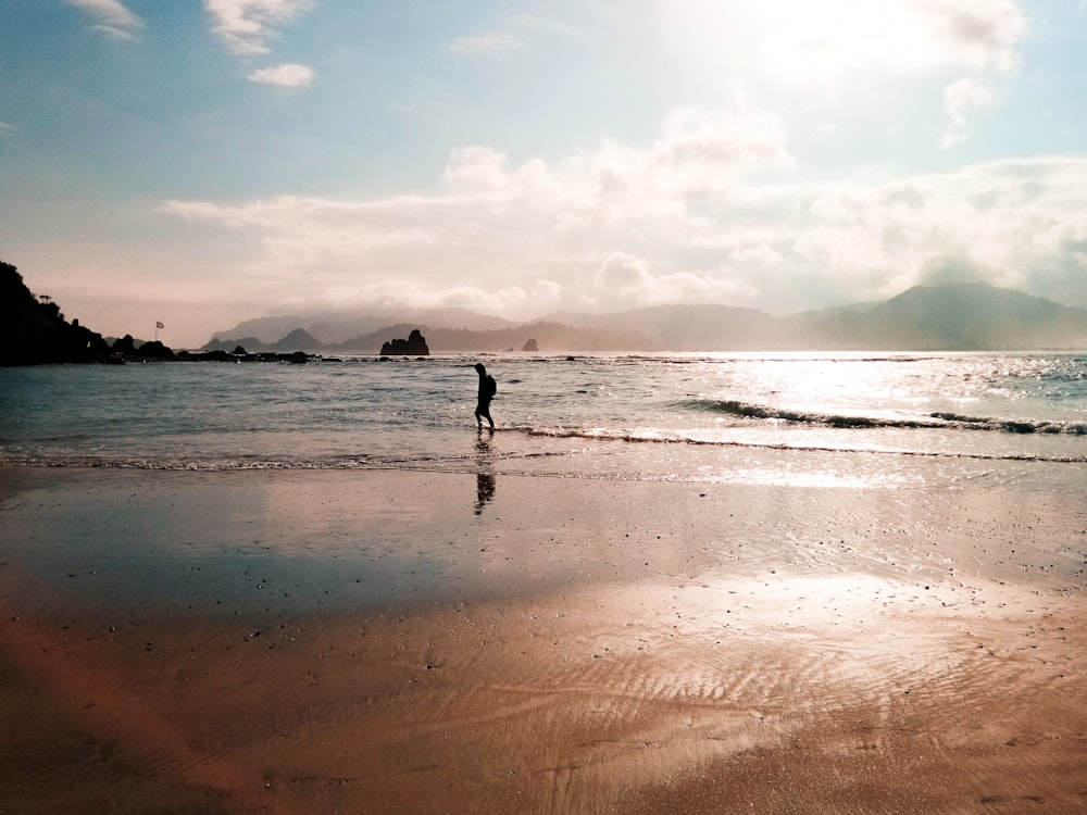 person walking on a beach