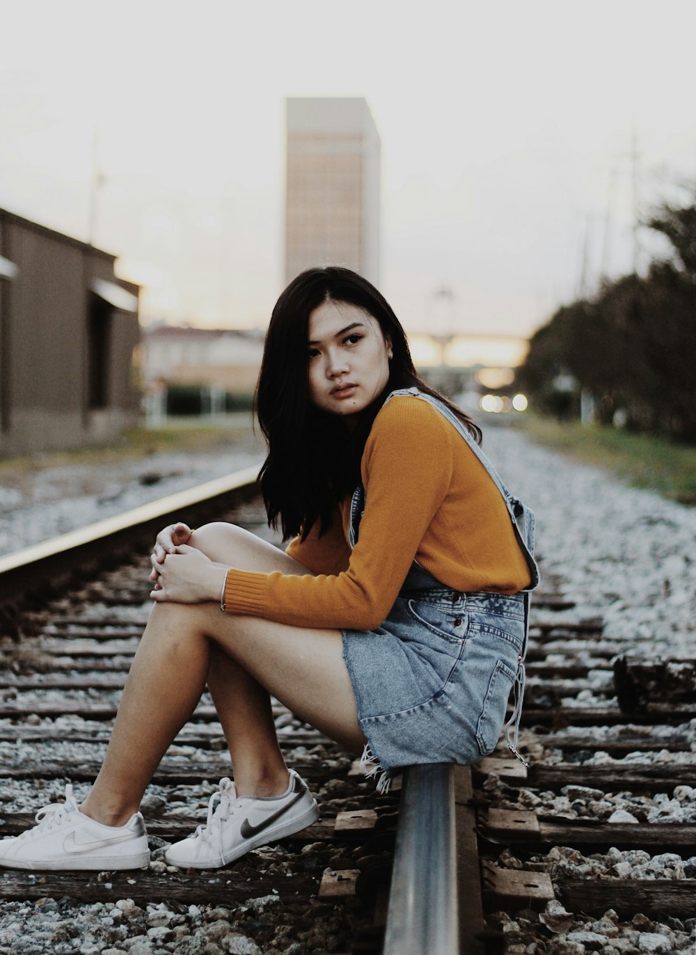 woman sitting on railway
