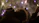 Bride and groom smiling under a sky lit with colorful fireworks at a nighttime wedding celebration.