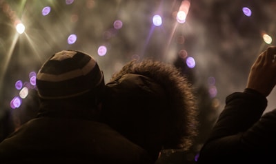 Happy family watching fireworks together in a backyard party.