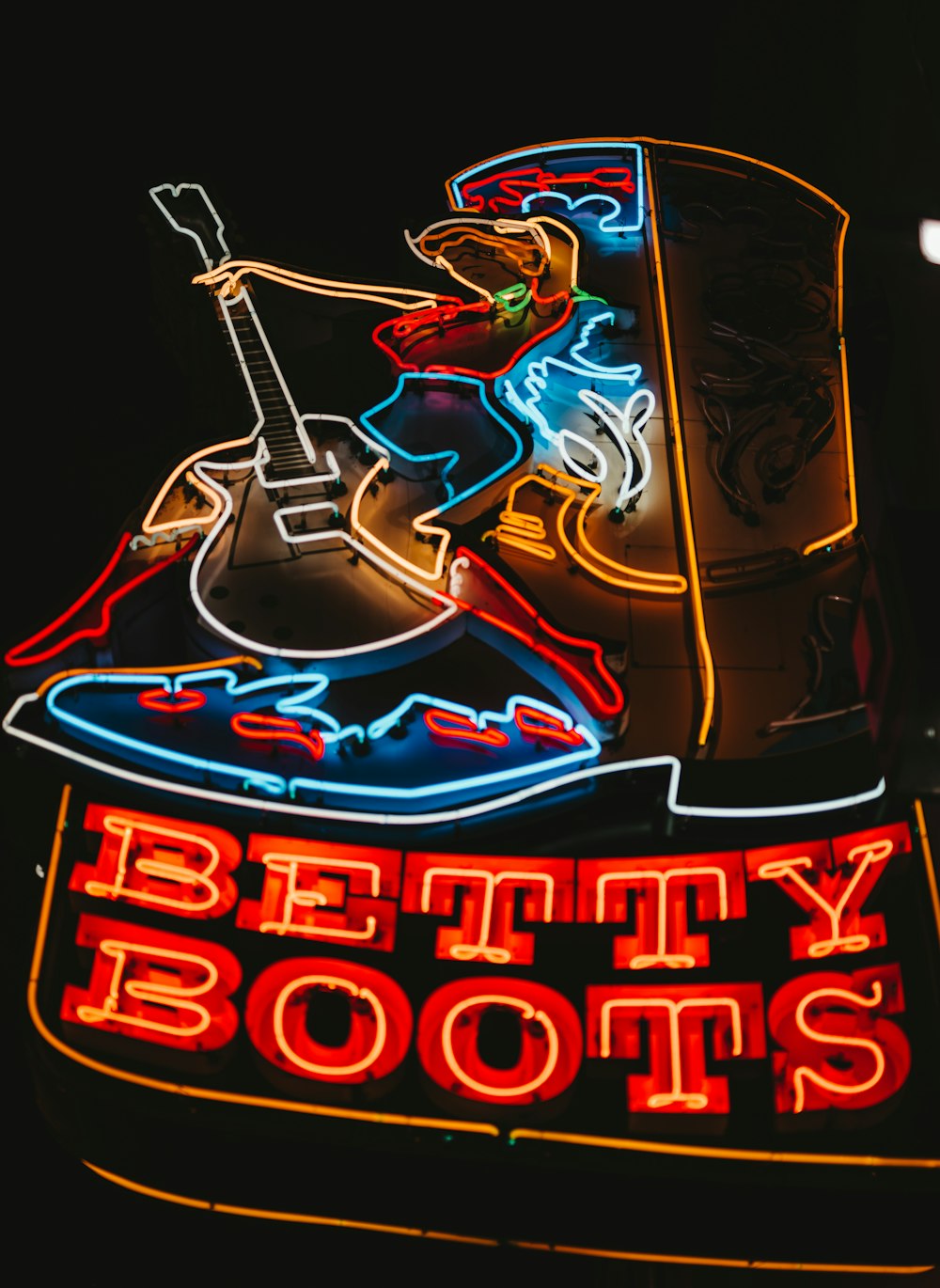 turned-on Betty Boots neon signage at night