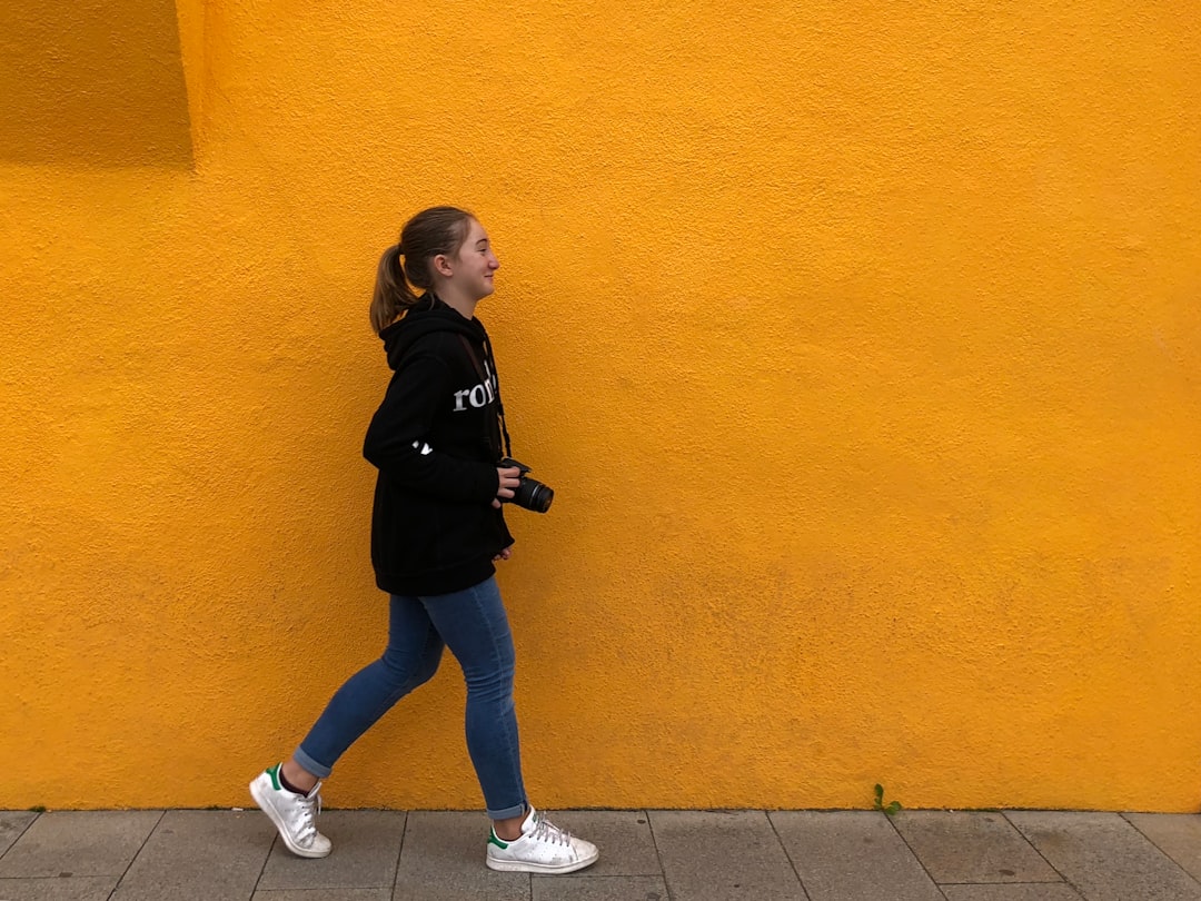 girl walking on sidewalk