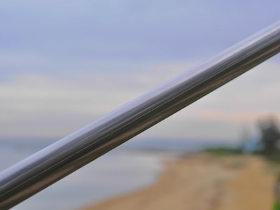Rust-proof aluminium railing gleaming under sunlight on a seaside terrace.