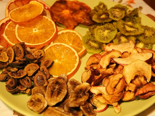 A colorful plate of healthy snacks including nuts, dried fruits, and fresh berries arranged artfully.