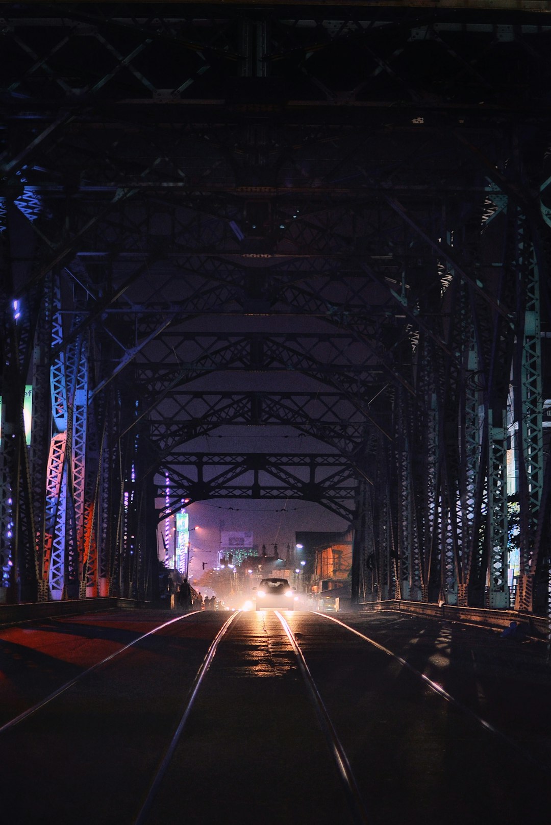 car on road under bridge at nighttime