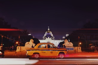 timelapse photography of sedan on road at night