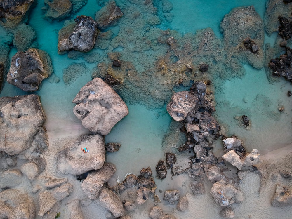 aerial photography of rocks on shore during daytime