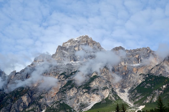 low angle photo of mountains covered with fog in ‎⁨San Vito di Cadore⁩ Italy