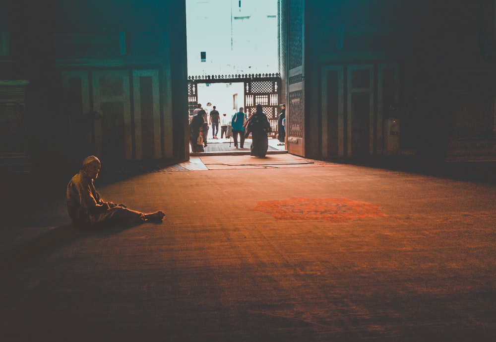 man sitting inside temple during daytime