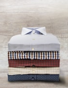 A collection of custom shirts folded neatly.