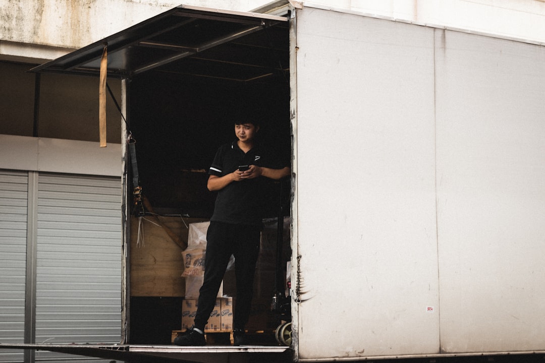 man inside a van wearing black shirt and pants