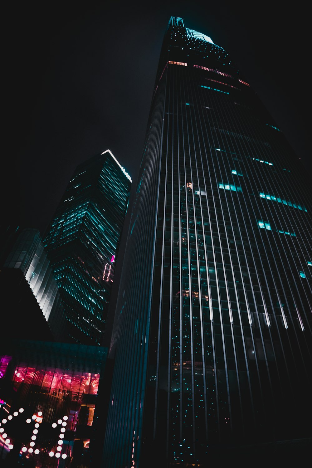 low-angle photography of black high-rise building