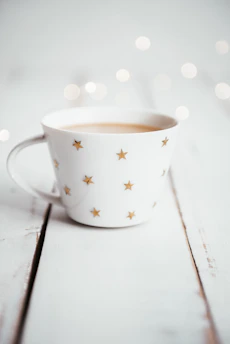 Elegant star mugs steaming gently on a dark wooden table with violet accents