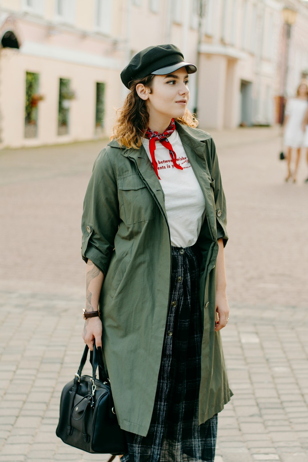 standing woman in green coat