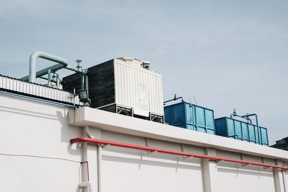 white and black standby generator on top of white concrete building