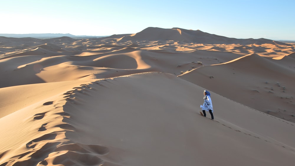 person walking on desert