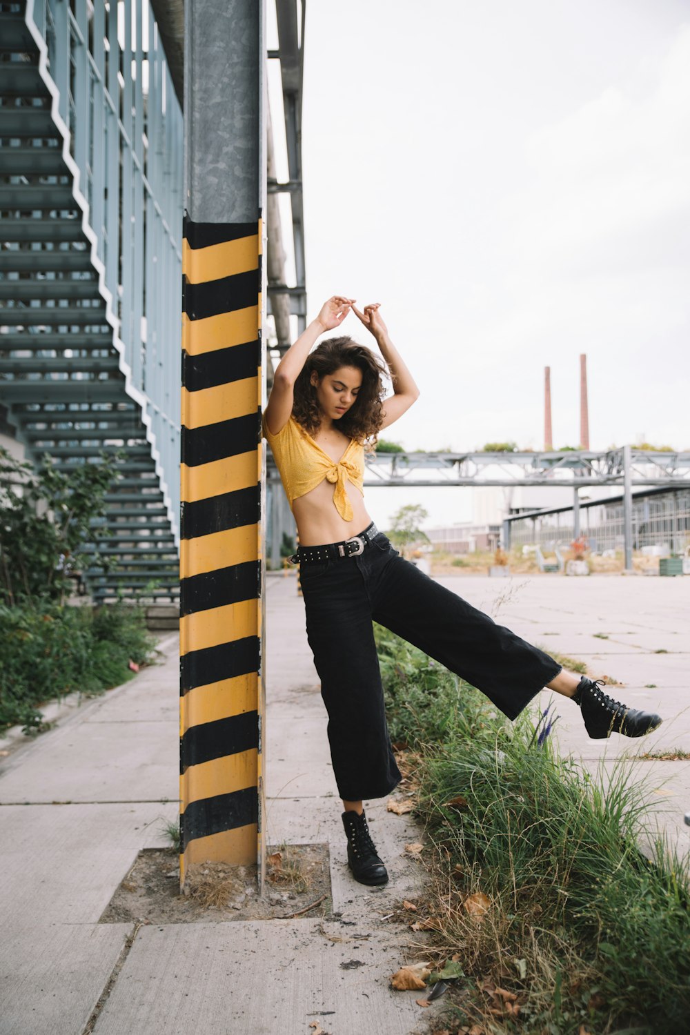 woman standing beside post