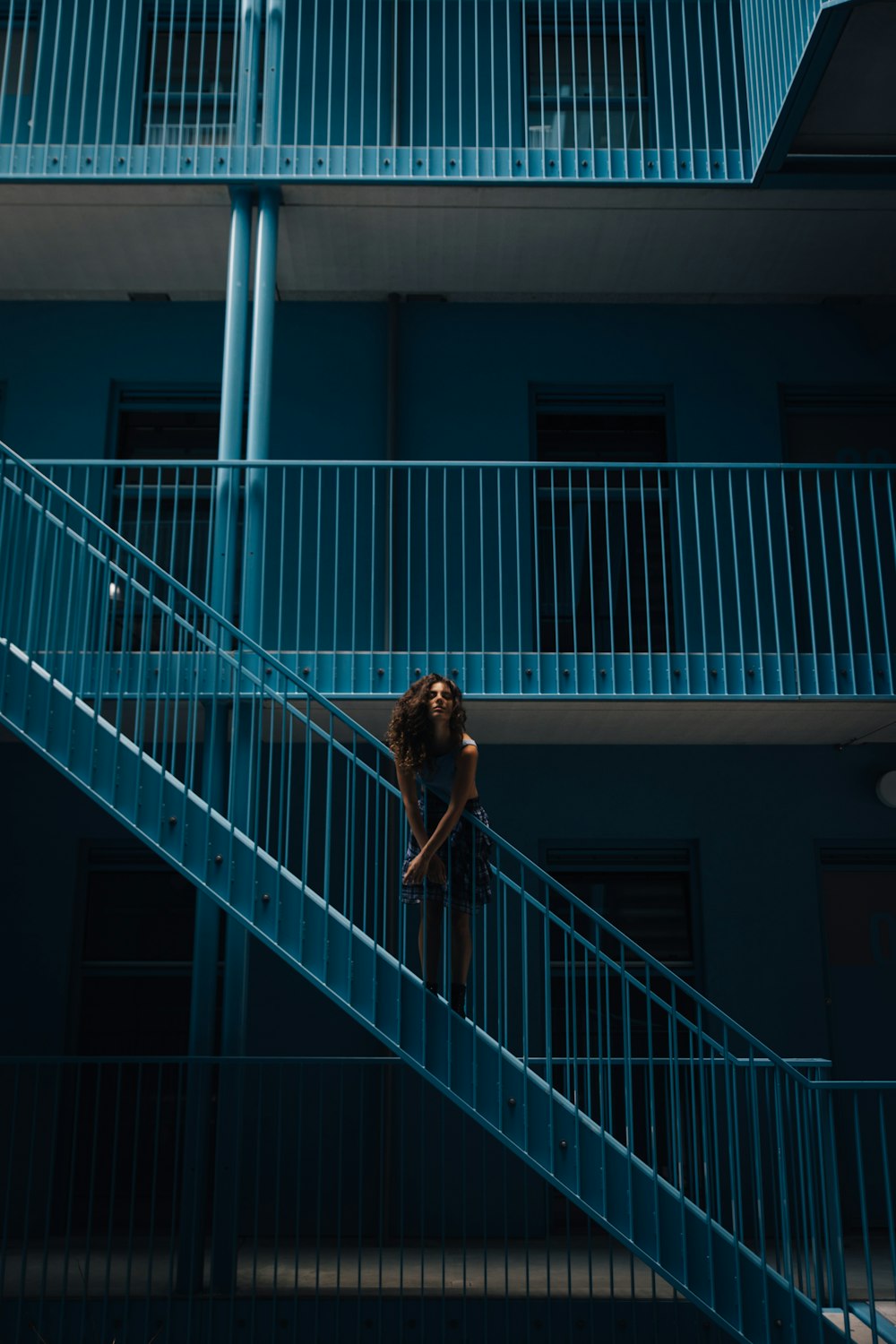 woman standing on stairs during daytime