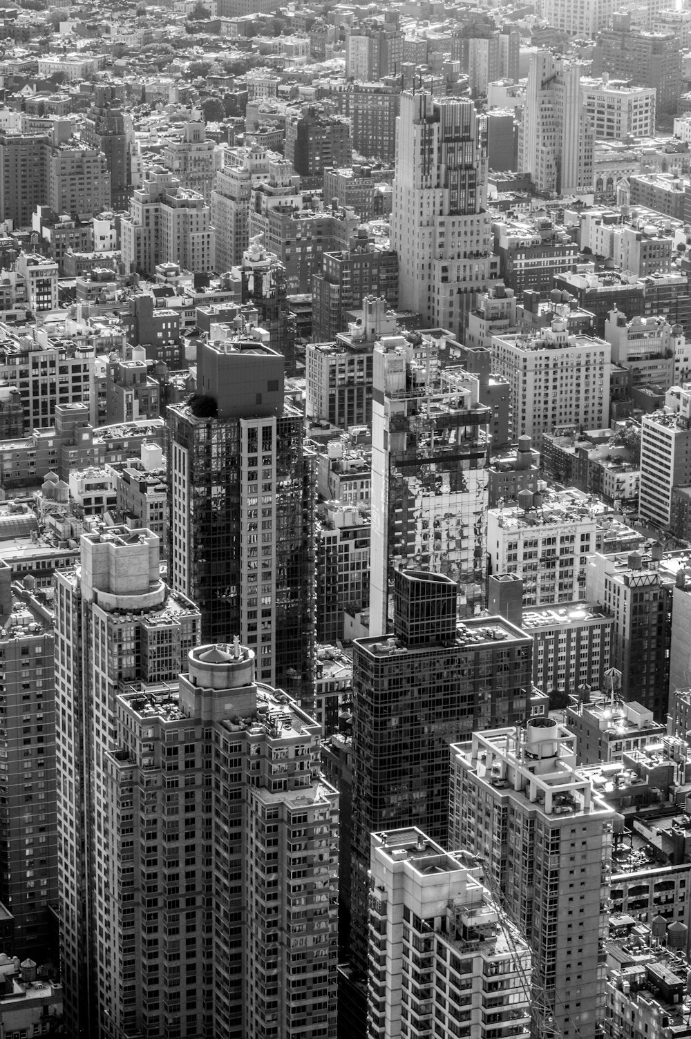 grayscale photography of concrete high-rise buildings at metropolitan area