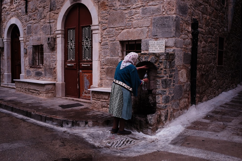 woman standing beside wall