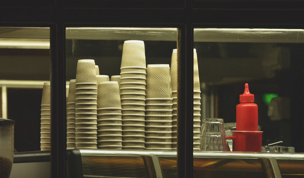 pile of disposable cups on white surface