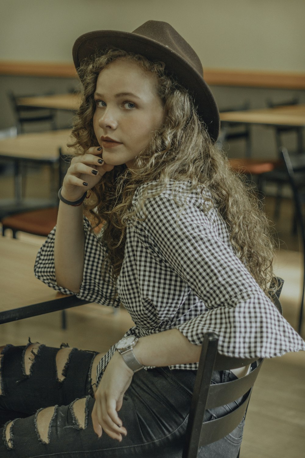 woman sitting on ladder chair beside table