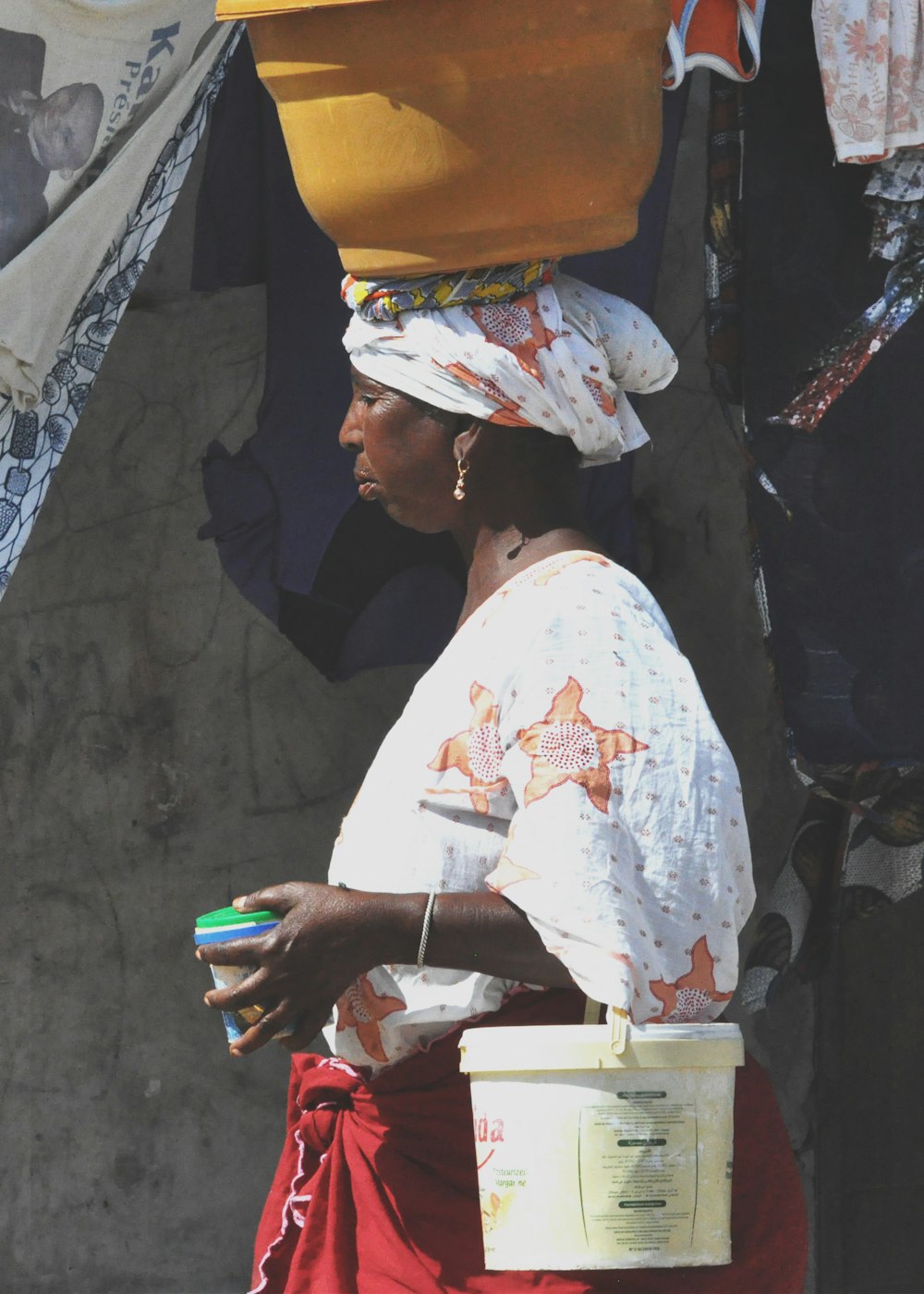 woman carrying bucket