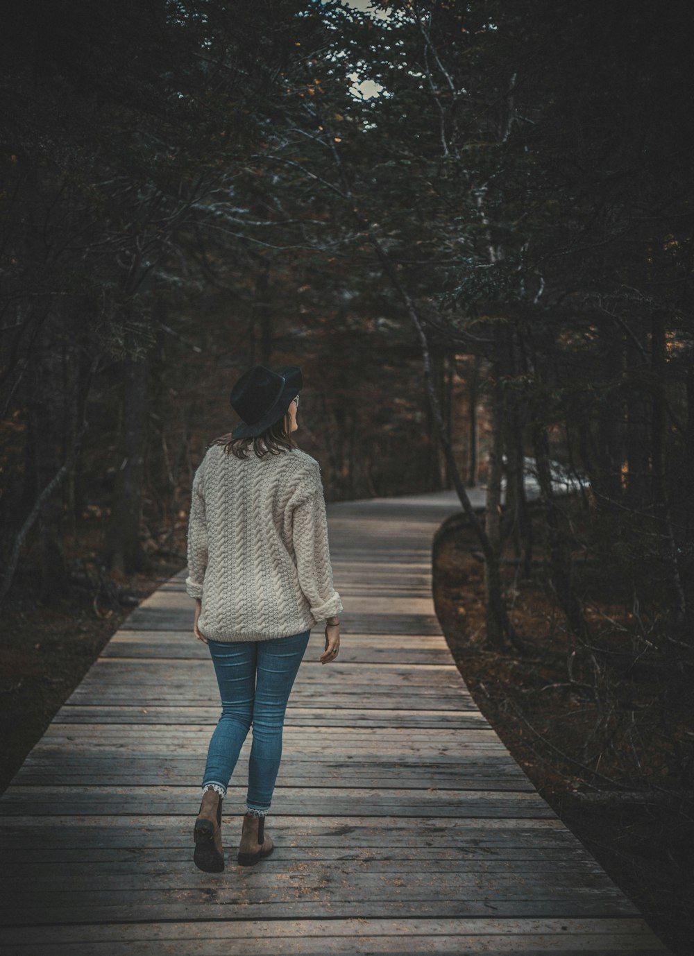 woman walking on wooden alley