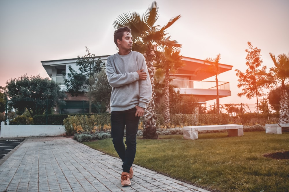 man walking on pathway during golden hour