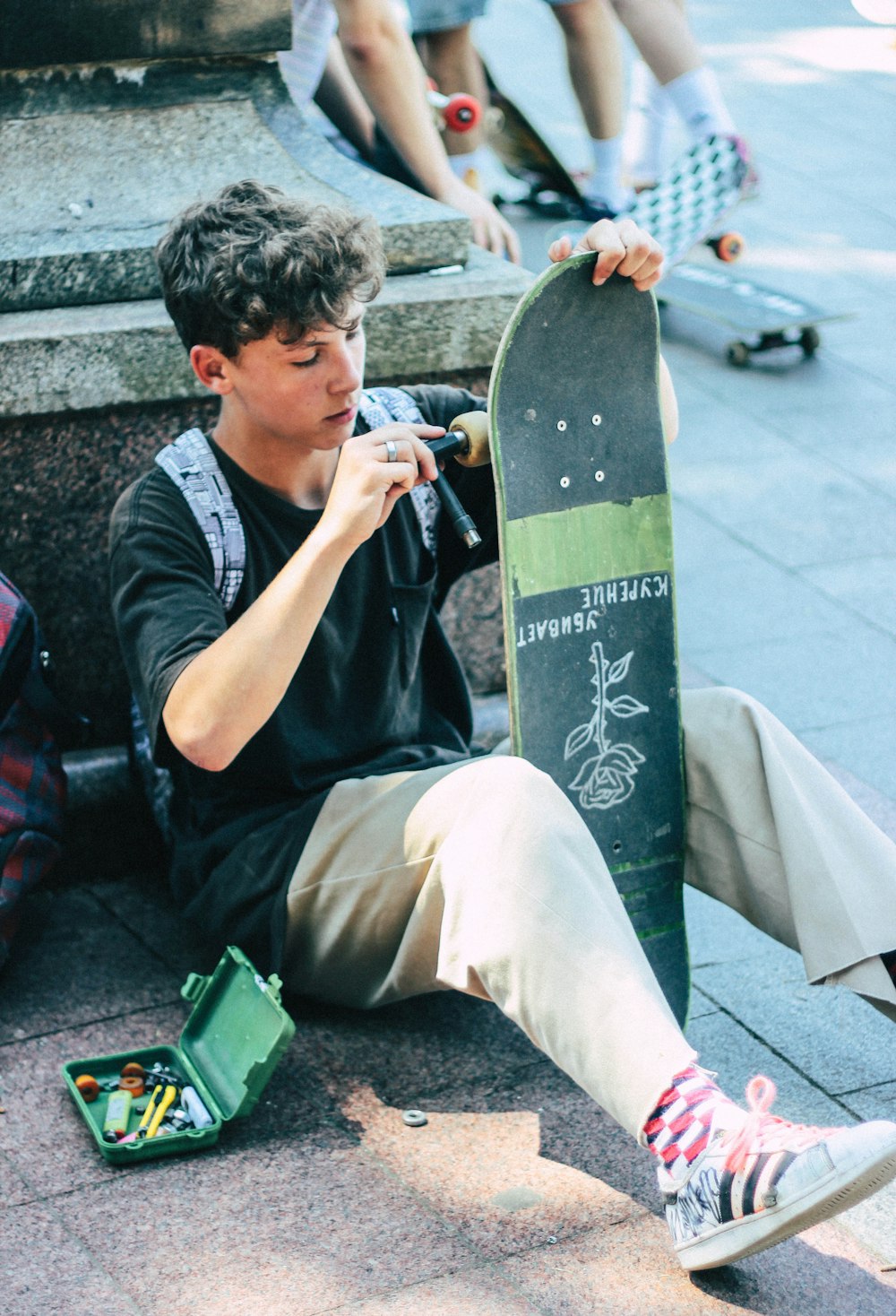 man fixing his skateboard