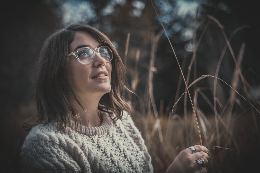 woman surrounded by brown grass