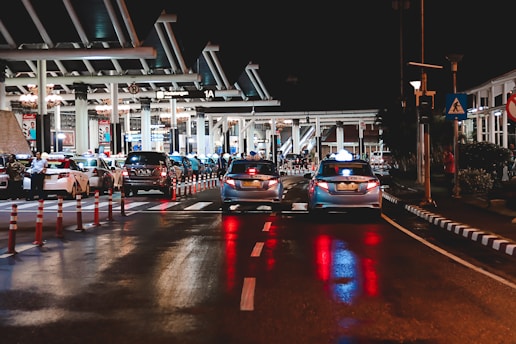 cars on road near station during night