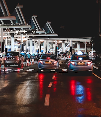 cars on road near station during night