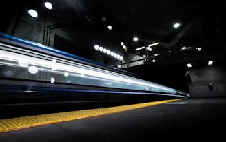 timelapse photography of train passing on track