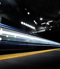 timelapse photography of train passing on track