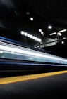 timelapse photography of train passing on track