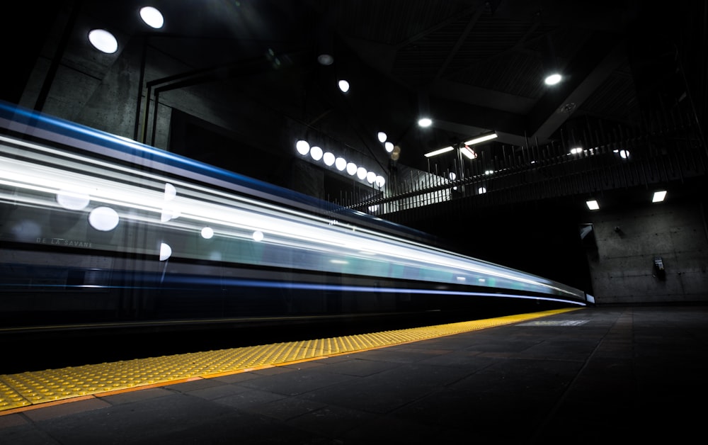 timelapse photography of train passing on track