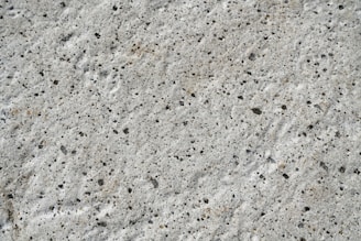 Close-up of a smooth, freshly finished concrete surface on a construction site.