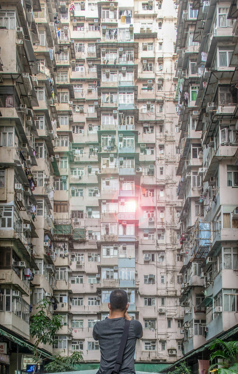 man standing fronting high-rise building