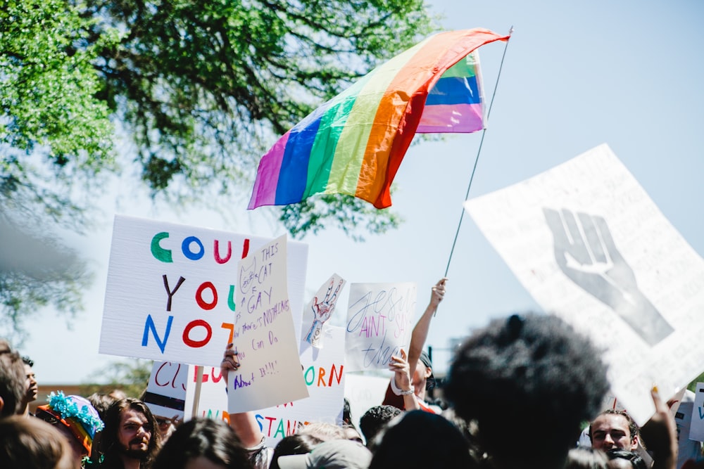 person holding LGBT flag