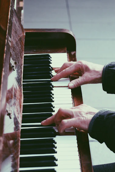 A lively piano class in session with students of various ages focused on their keyboards.