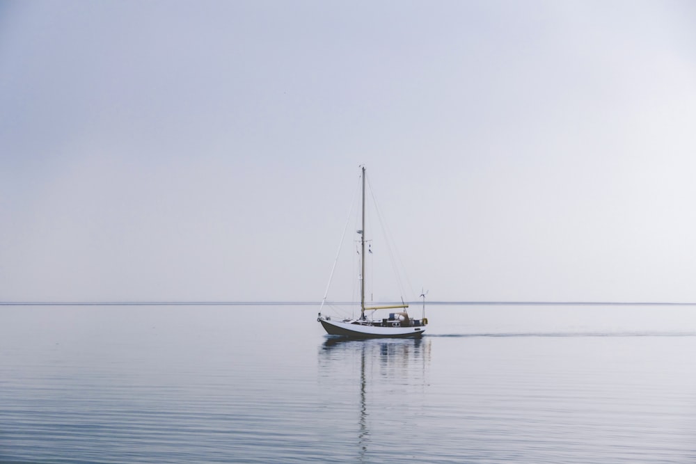 white boat in middle of ocean during daytime