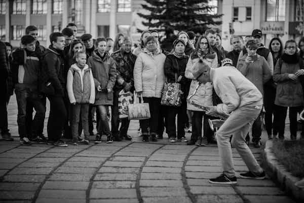 street musician playing to crowd of people