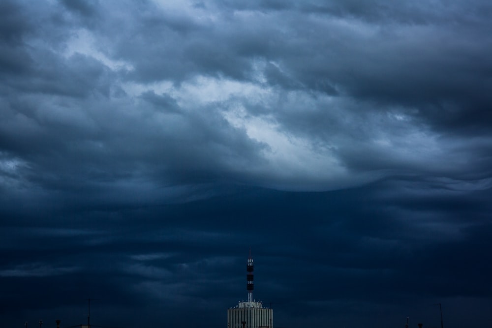 high-rise building and gray clouds
