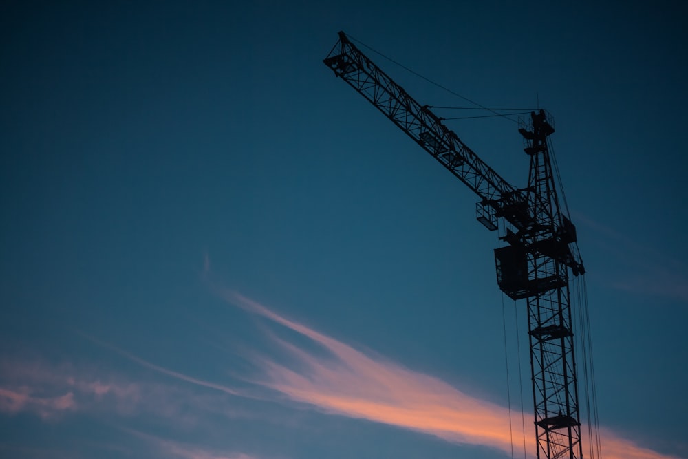 silhouette photo of tower crane